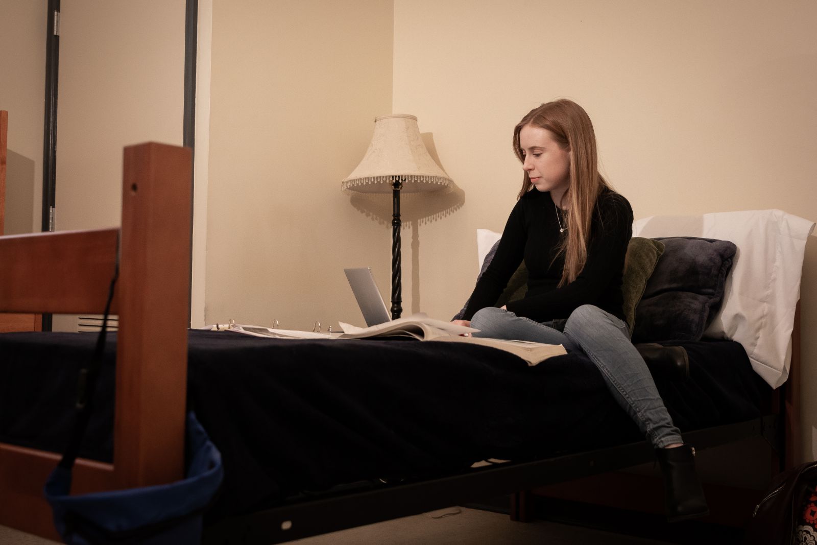 Student in dorm room studying