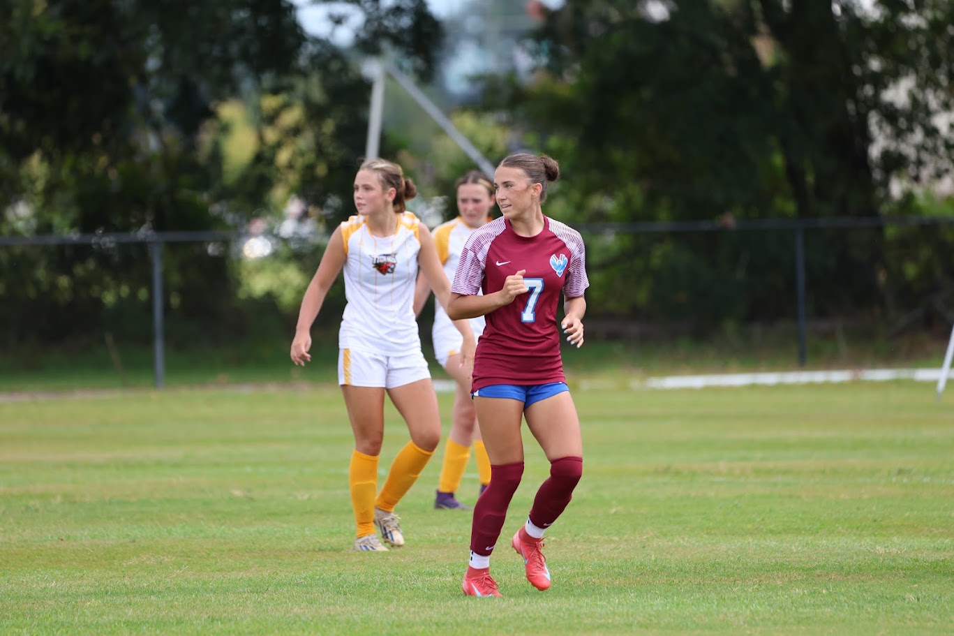 3 soccer players on a field